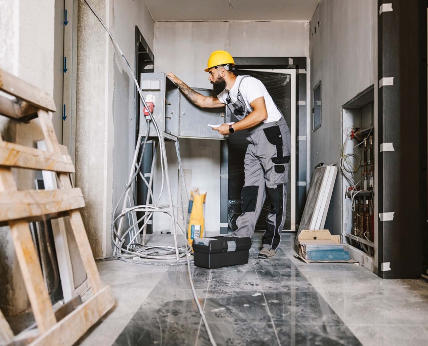 An electrician fixing electricity in an building in construction process_