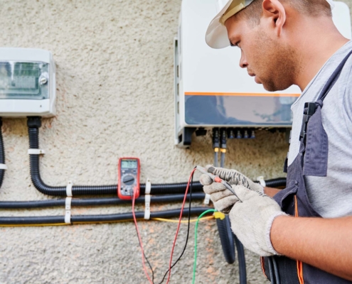 Man electrician installing solar panel system_