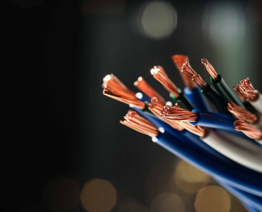 Stranded copper wires with insulation against blurred background, closeup_