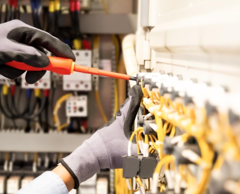 Professional adjusting cables in electrical box